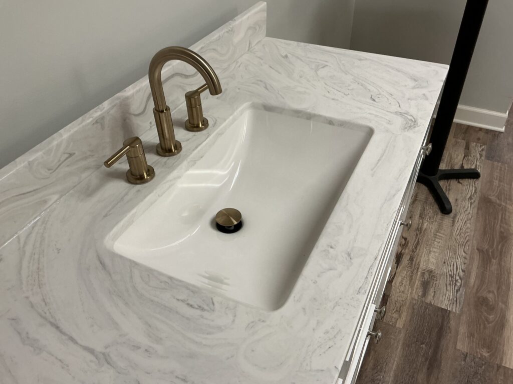 Contemporary bathroom featuring grout-free cast marble surfaces