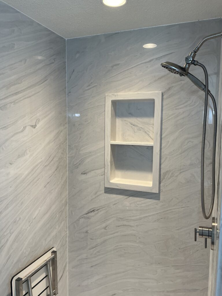Compare marble vs acrylic shower systems, including durability, maintenance, style, and value to find the best fit for your bathroom remodel.